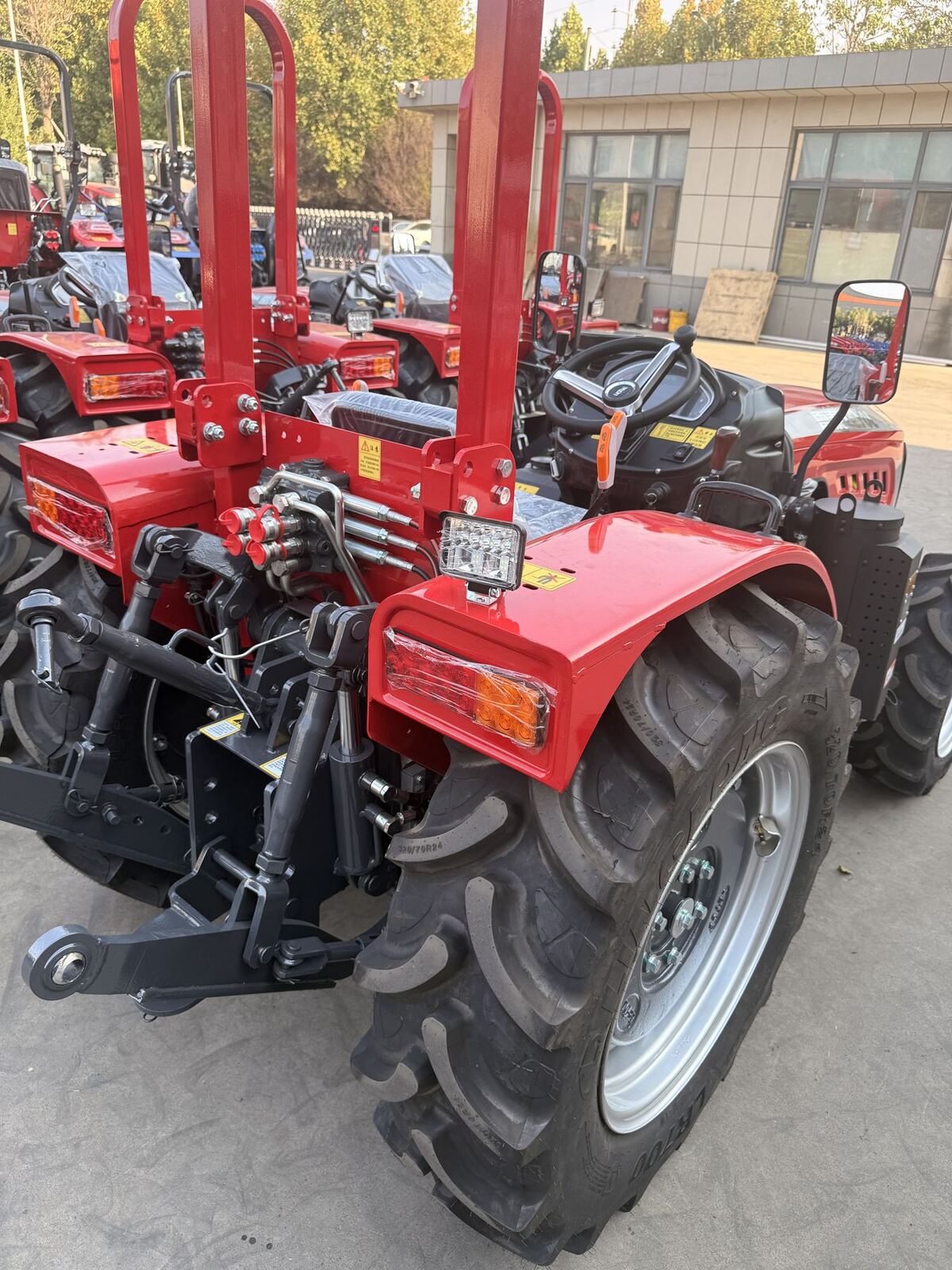 Red compact tractor with three-point hitch
